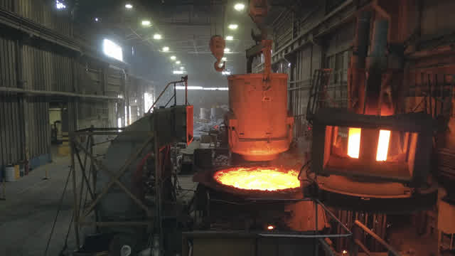 Hornos encendidos, chispas de esmeril y metal al rojo dentro de una planta industrial.